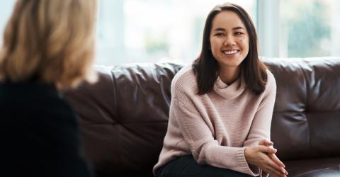Woman on couch speaking to therapist