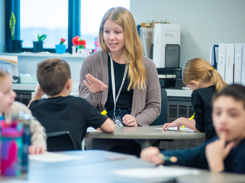 Teacher in the classroom working with students.