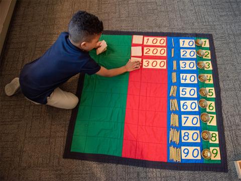 Montessori student working through math problems